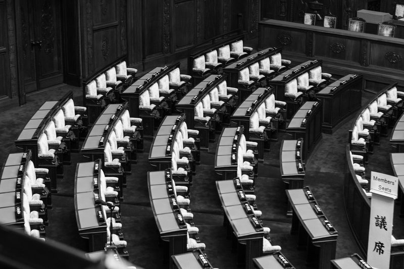 An empty council chamber with rows of seating